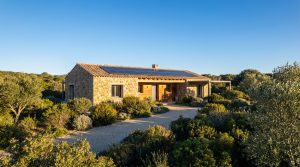 Maison corse moderne équipée de panneaux solaires sous un ciel bleu hivernal lumineux en début d'année 2026